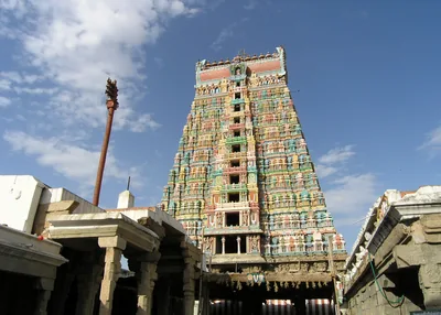 The tall painted gopuram of the Andal temple at Srivilliputhur under a blue sky