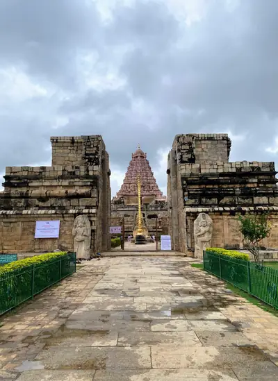 View down a stone path through a gateway to the temple tower