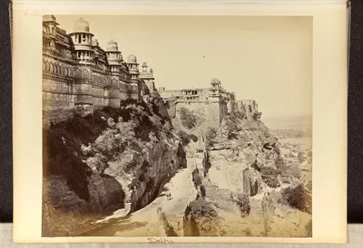 Old photograph of the high walls and towers of Gwalior Fort on its cliff