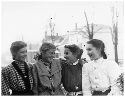 An old photo of four young women laughing together
