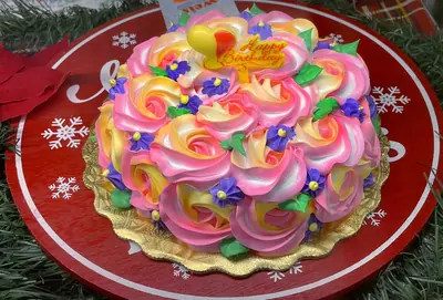 A cake covered in bright icing flowers