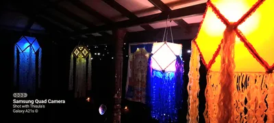 A glowing paper lantern hangs in a temple hall at night
