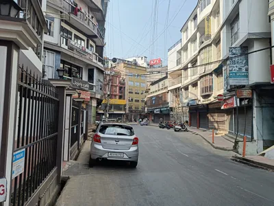 A hillside street in Aizawl lined with tall colourful buildings