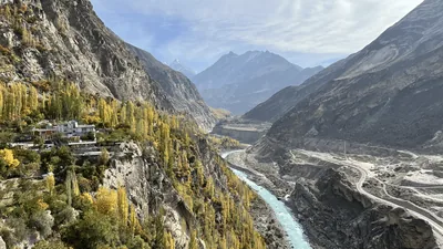 The Indus river winding through a deep mountain valley with autumn trees