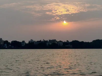 The evening sun setting over a wide river, the time of the Sandhya Arghya