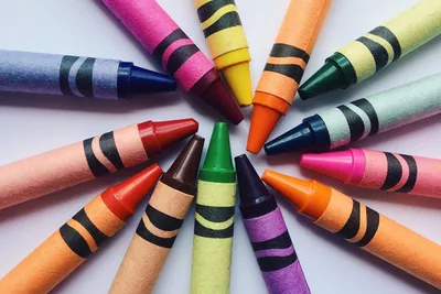 Bright wax crayons arranged in a circle