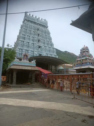 Temple towers and a courtyard with green hills behind