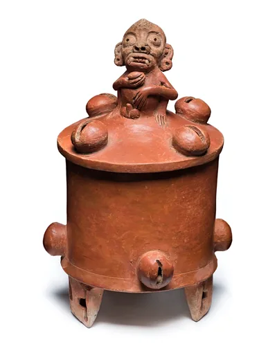 An old clay vessel shaped with cacao pods