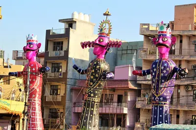 Tall, colourful effigies of Ravana standing ready for Dussehra evening