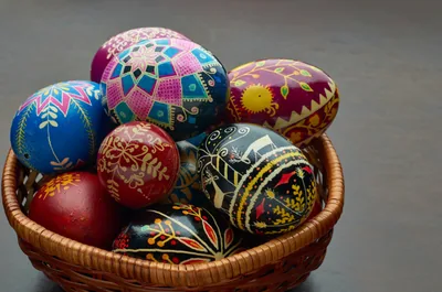 A basket of hand-painted Easter eggs with bright folk patterns