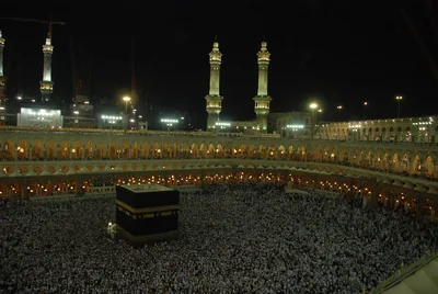 The Grand Mosque of Mecca lit at night with tall minarets