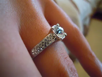 Close view of a diamond engagement ring on a hand