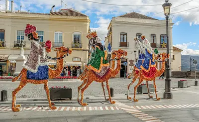 Colourful figures of the Three Kings on camels in a town square