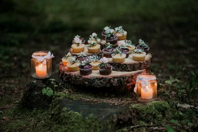 Cupcakes on a wooden stand with glowing jars
