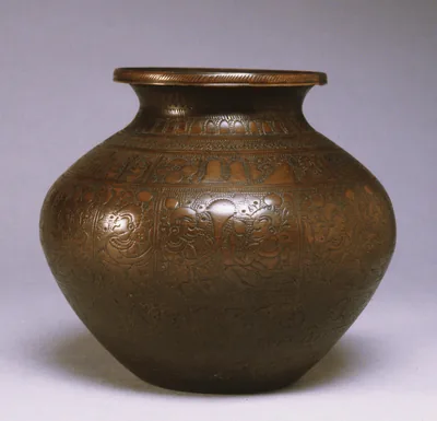 An old engraved metal water pot