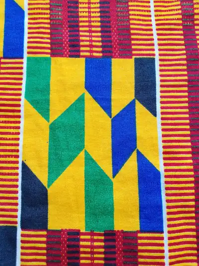 Woven kente cloth in yellow, green, blue and red
