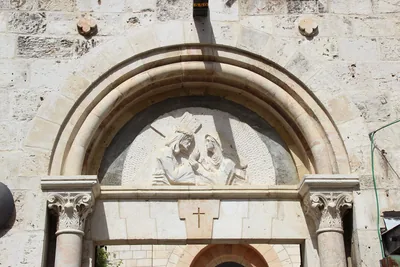 A stone carving over a doorway on the Way of the Cross