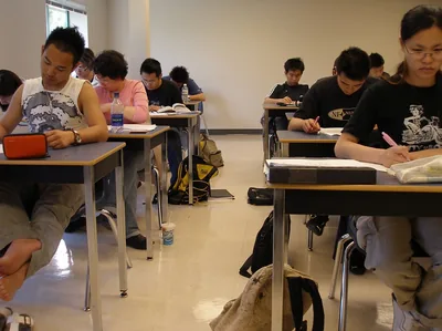 Students writing at desks during an exam