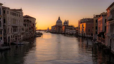 A canal and church dome in soft early light