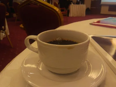 A white cup of coffee on a saucer