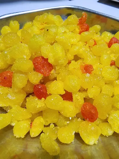 A heap of bright yellow and orange boondi sweets