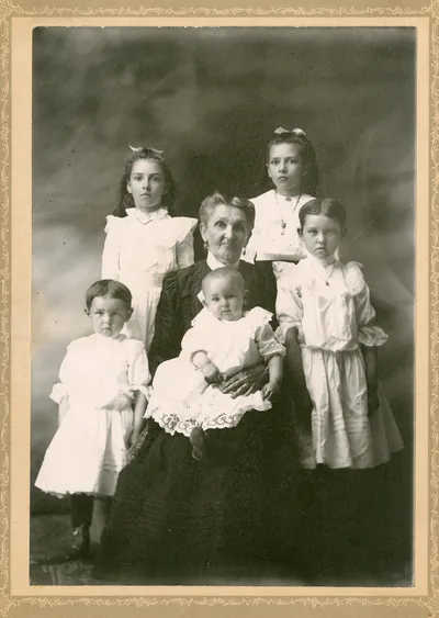 An old photo of a grandmother with her grandchildren