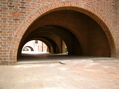 Long red brick arches of a campus walkway