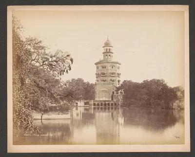 Old photo of a tall tower gurdwara beside a pool