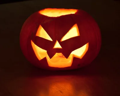 A glowing carved jack-o-lantern