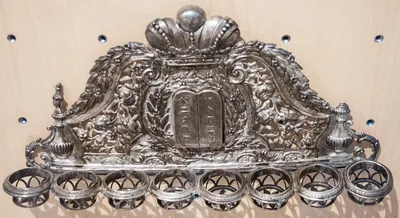 An ornate old silver Hanukkah lamp