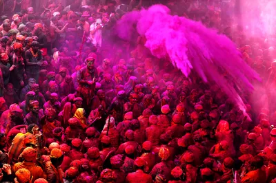 A crowd covered in pink colour with a pink cloud rising above