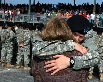 A soldier hugging family at a reunion