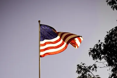 The American flag waving against a clear sky