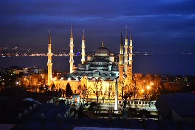 A great mosque with six minarets lit at dusk