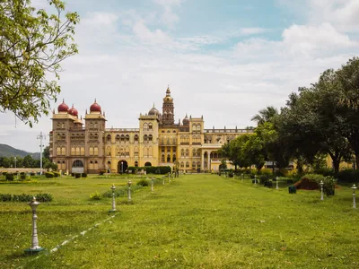 The Mysuru Palace with its domes behind a wide green lawn