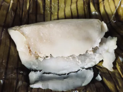 A soft steamed rice cake on a banana leaf