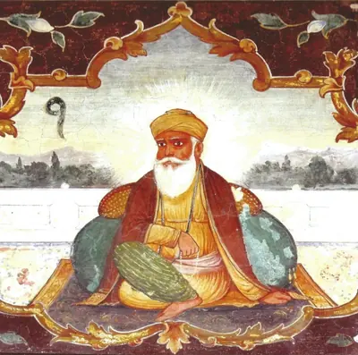 An old fresco of Guru Nanak seated, painted above a gateway