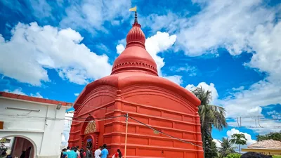 The red domed Tripura Sundari temple under a bright blue sky