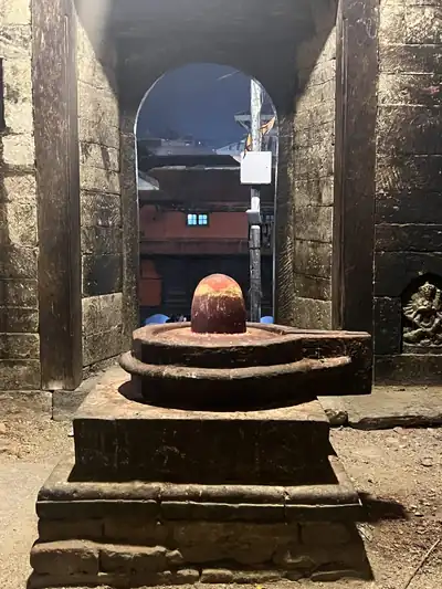 A Shiva lingam in an old stone shrine