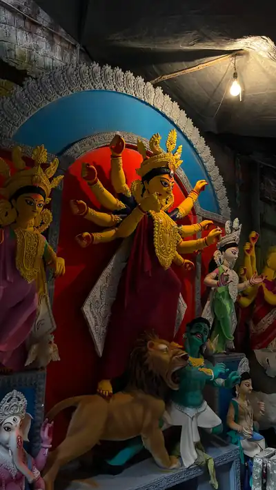 A large painted image of Goddess Durga with her lion and other deities in an image makers workshop