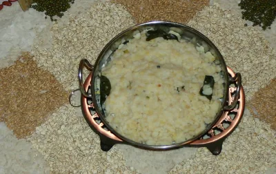 A metal pot full of sweet rice pongal