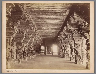 Old photo of a long hall of carved pillars
