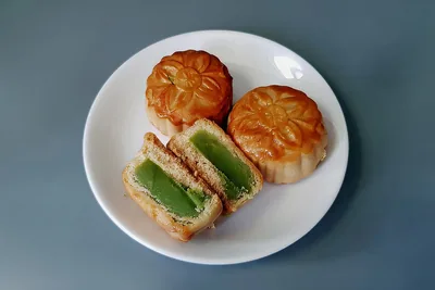 Mooncakes cut open on a white plate