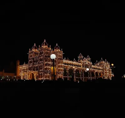 The Mysuru Palace lit with thousands of golden bulbs at night during Dasara