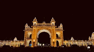 A palace gateway glowing with thousands of light bulbs at night