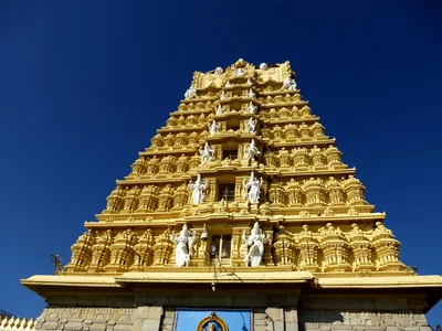 A golden temple tower against a deep blue sky