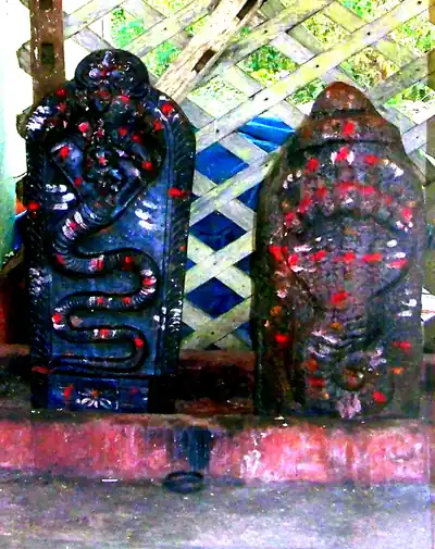 Naga stones painted and smeared with red kumkum at a shrine
