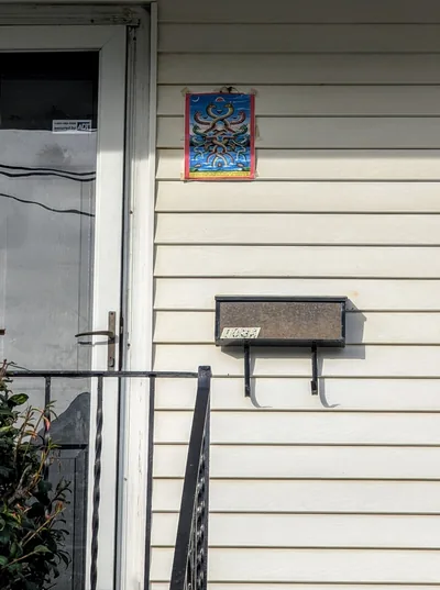 A picture of nagas fixed above the door of a house