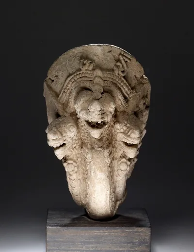 An old stone carving of a naga with three hooded heads