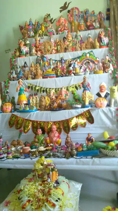 Rows of colourful dolls of gods, people and animals arranged on white-covered steps